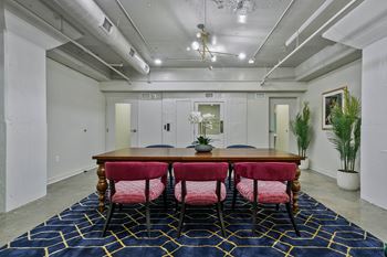Dining area with wood table and pink velvet chairs